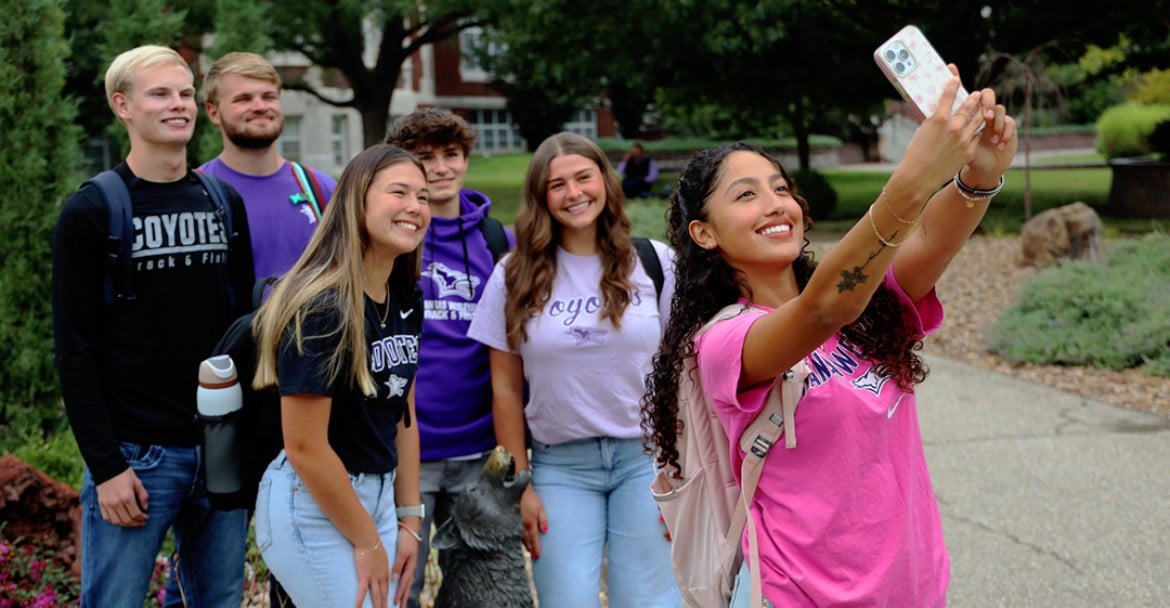 a group of people that are standing in the grass